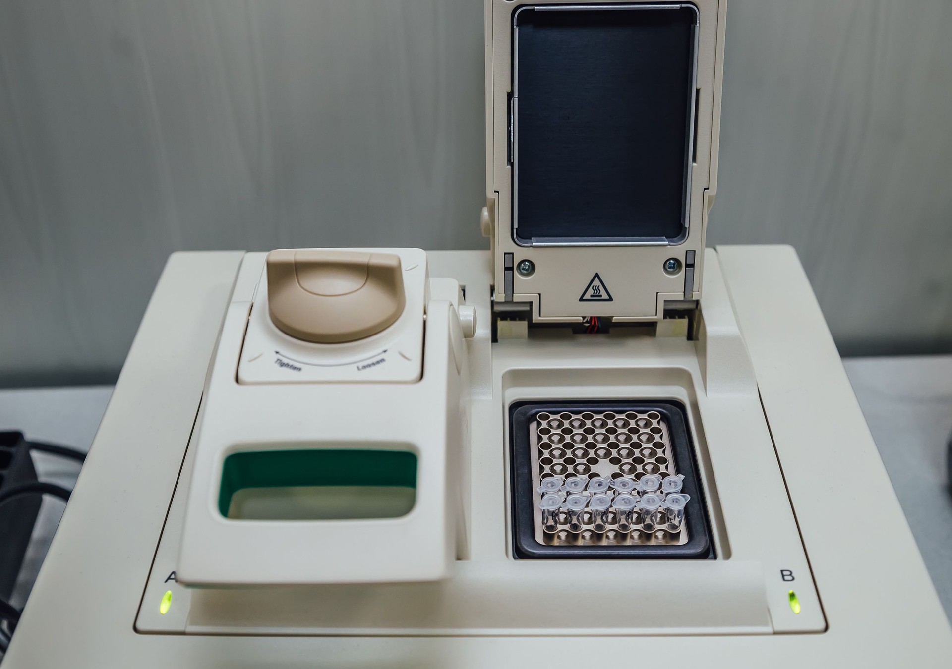 Opened polymerase chain reaction (PCR)  cycler machine with DNA samples